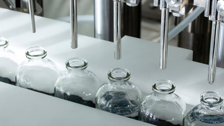 Medical glass jars are filled in a sterile environment